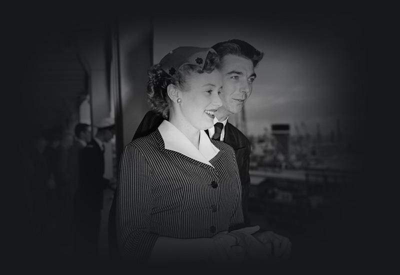 Barbara Porritt and her husband standing at the rail of a ship.