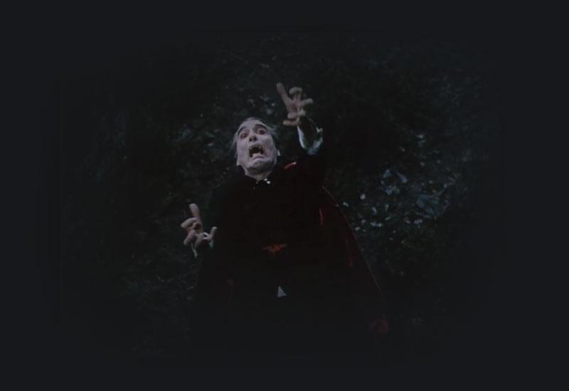 Dracula being melodramatic with arms outstretched.