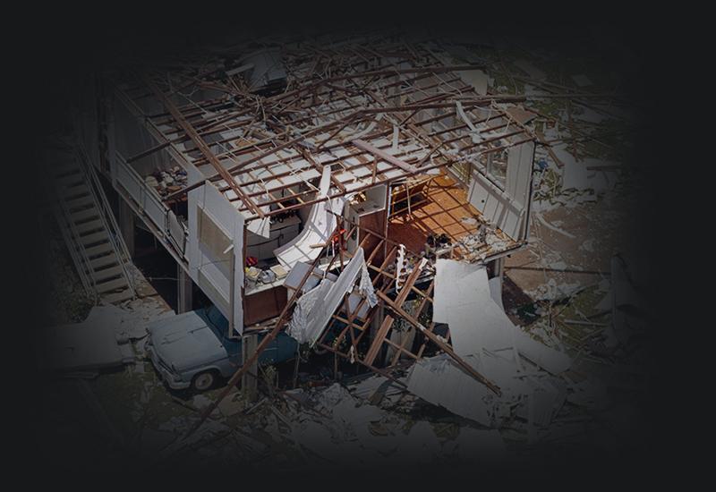 Partially demolished timber house.