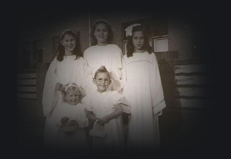 Nonja and 4 young girls beside a house in 1948