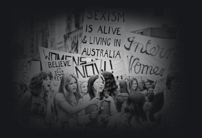 A protest march of people holding signs.