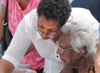 Phyllis Williams and her mother Yula pointing out a thumbprint on the Larrakia petition.