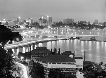 An evening view of Swan Brewery, night lights and the city beyond.