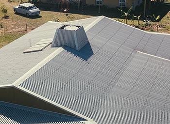 Corrugated steel house roof and car.