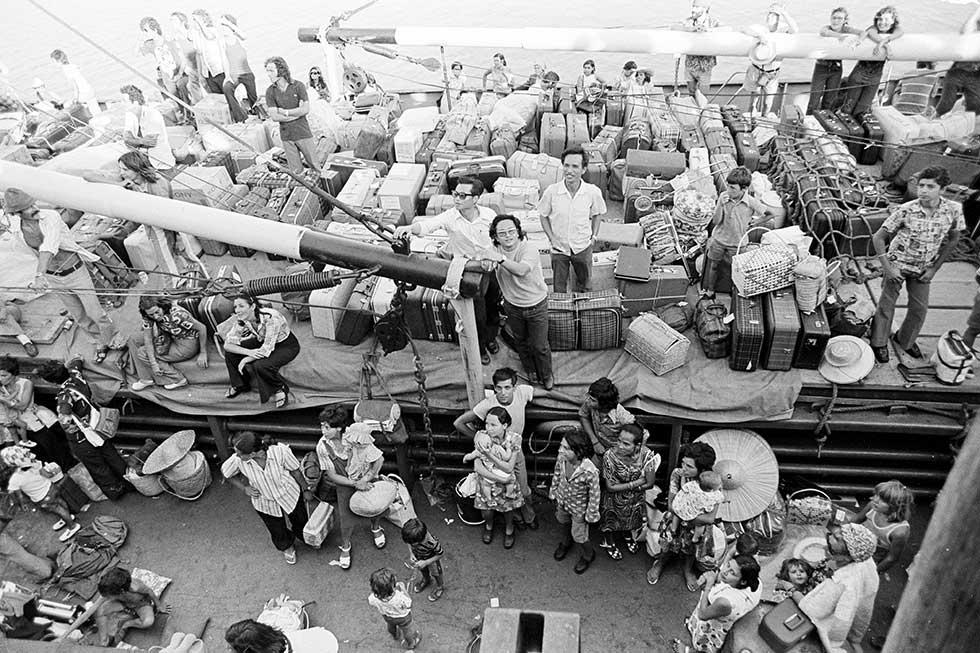 East Timorese refugees: men, women and children on the decks of a freighter, along with their luggage.