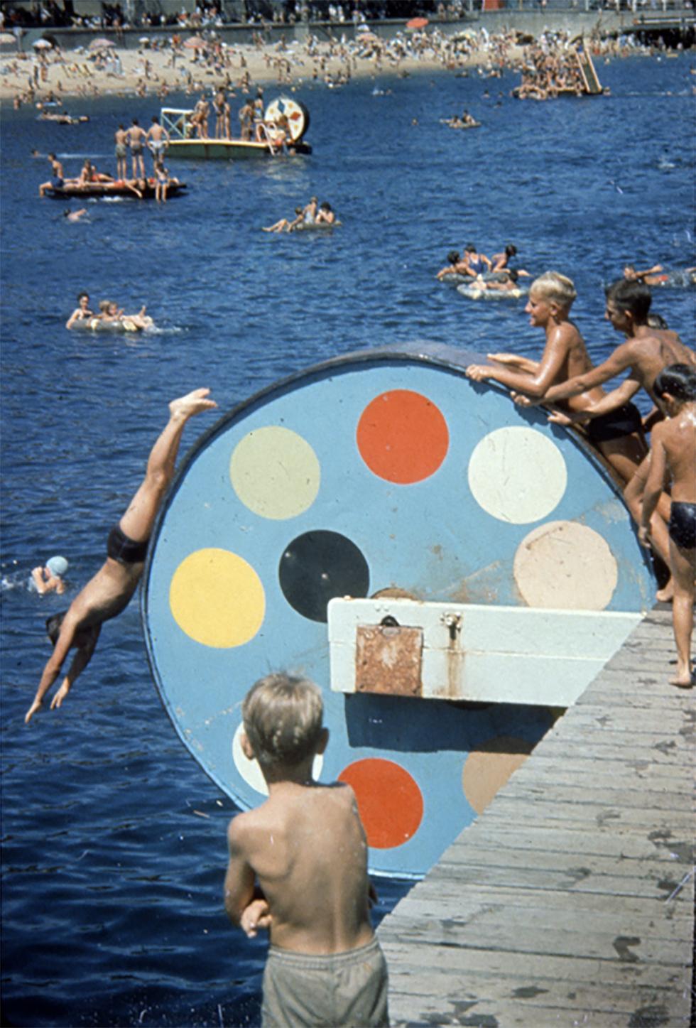 Young children diving off a special apparatus at Manly, New South Wales, in January 1960.