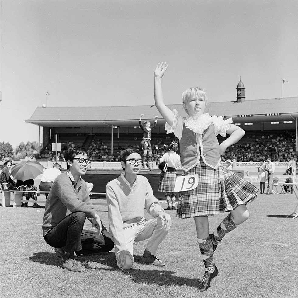 Vietnamese students watching Scottish dancing at a multicultural festival in Adelaide.