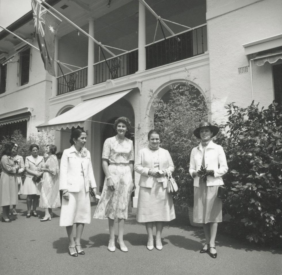 Four women including Tammy Fraser and Queen Alia of Jordan standing outside the lodge. 