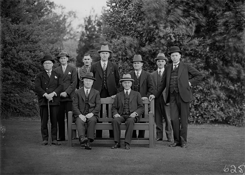 Lyons and Governor-General Sir Isaac Isaacs with members of the Cabinet, photographed in a park.