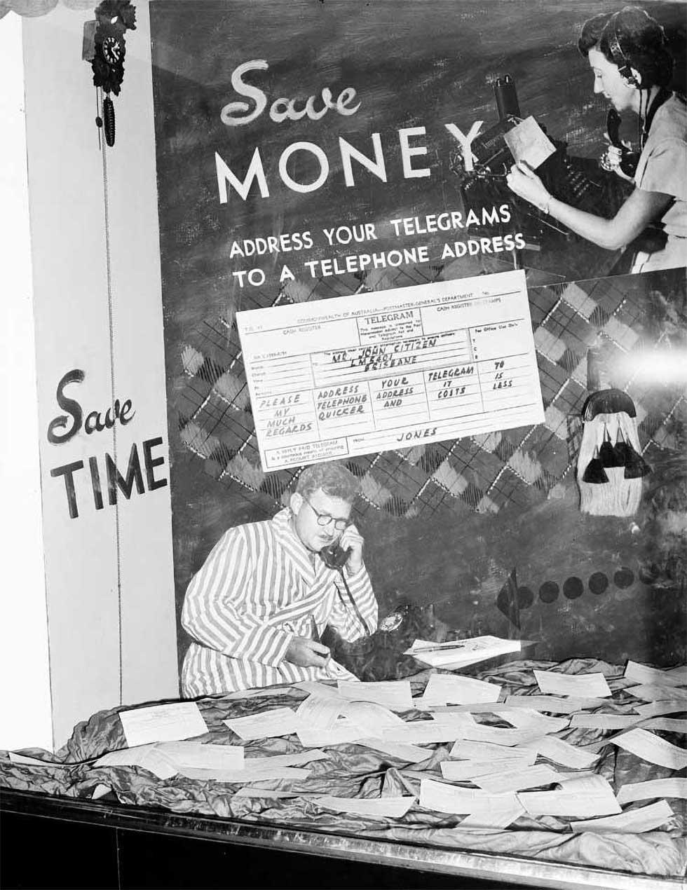 Telegraph office window display, text: 'Save MONEY – ADDRESS YOUR TELEGRAMS TO A TELEPHONE ADDRESS'.