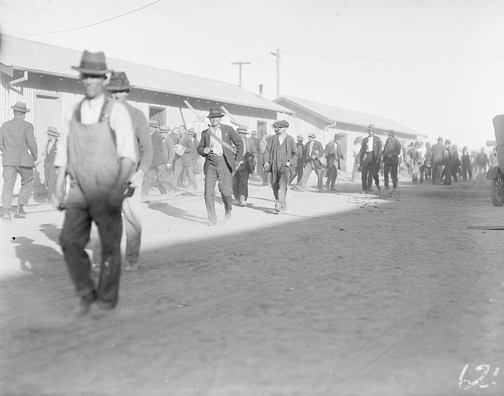 Construction workers leaving Old Parliament House at the end of a day. 