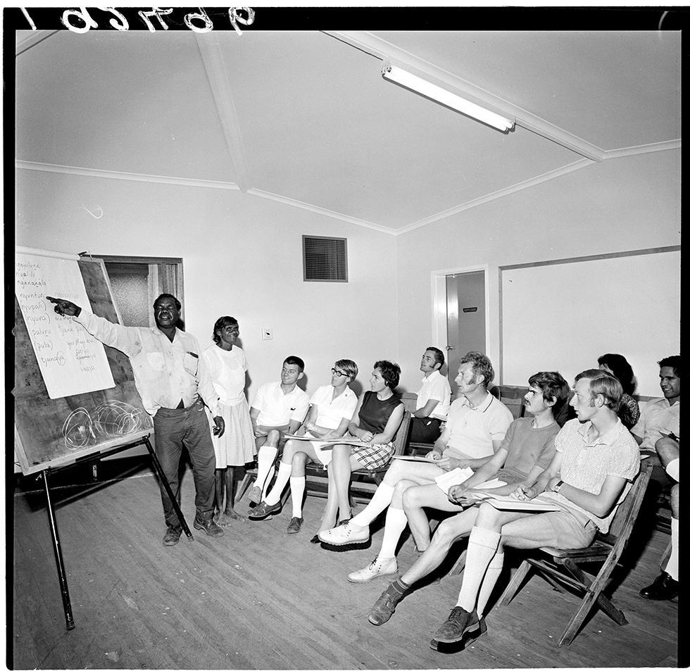 Two First Australians teaching Pitjantjatjara language to a group of adults in Alice Springs. 