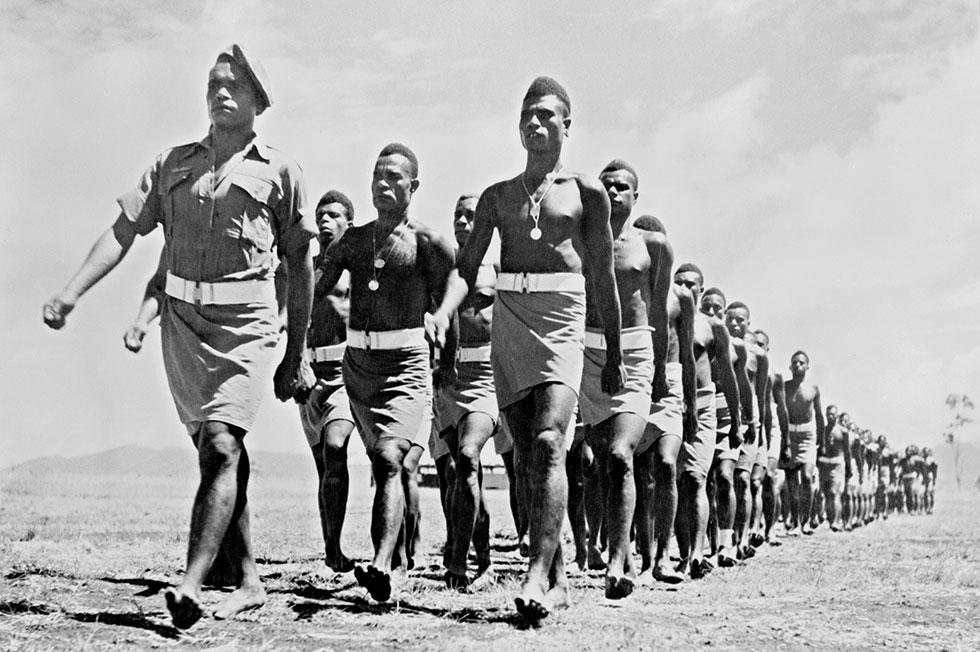 Men from the Royal Papuan Constabulary marching.