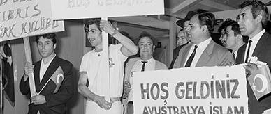 A group of men. Some holding signs written in Turkish Latin script.