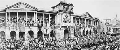 Crowd gathered on Brisbane's General Post Office balcony and Queen Street watching the Anzac Day march.