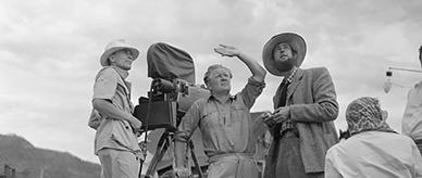 George Heath (left), Chips Rafferty (right) and a man in the centre captioned only as 'Haring', who may be Harry Watt, the film director.