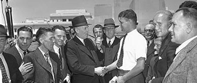 Photo of Prime Minister Chifley greeting postwar migrants.