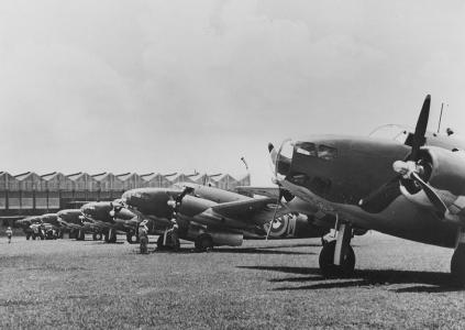 RAAF Lockheed Hudson bombers on an airfield. Aircraft hangar in the background.