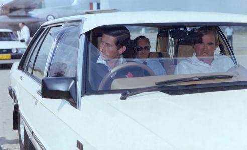 Prince Charles at the wheel of a white Commonwealth Ford LTD, Richmond RAAF Base