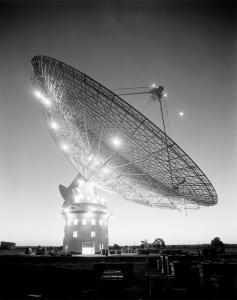 Parkes radio telescope illuminated in the evening.