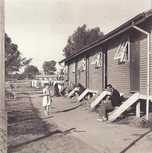 A child outside migrant accommodation houses. 