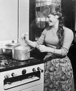 Vassiliki Daflou cooks on a gas stove,.