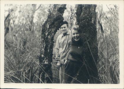 Voitre and Vera Marek smiling in a forest. 