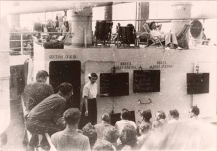 A woman conducting an English lesson on the ship's deck.