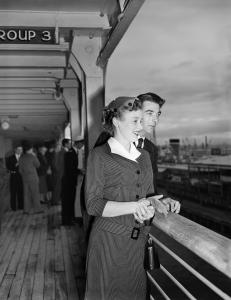 Barbara and Dennis Porritt at the rail of a ship.