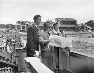 Barbara and Dennis being shown a plan on a construction site.