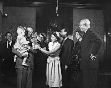Alexander Downer greets Cornelis Zevenbergen, who is holding one of his sons.