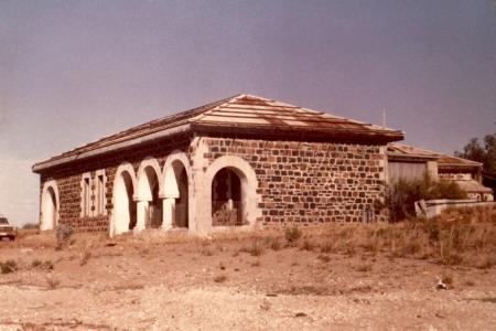 Stone building with triple arched portico