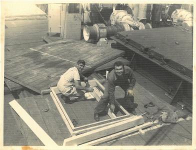 Tony Grima and Tony Ellul building timber framing aboard a ship.