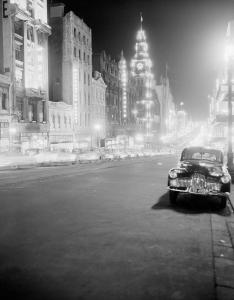 Night street scene featuring a parked Holden and stream of car tail lights.