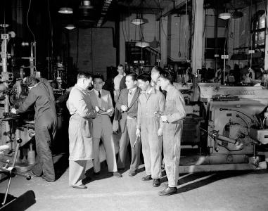 Men touring a factory.