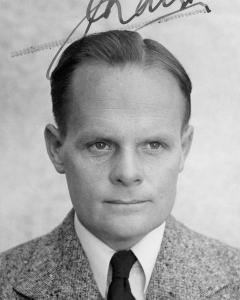 Portrait of Cliff Bottomley in shirt, tie and tweed coat.