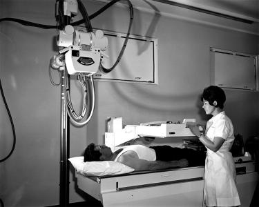 A radiologist operating a chest x-ray machine.