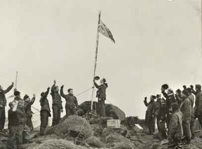 Captain Stuart Campbell of the Australian National Antarctic Research Expedition (ANARE) raising the Australian flag on Heard Island on 26 December 1947. NAA: A14518, L10032