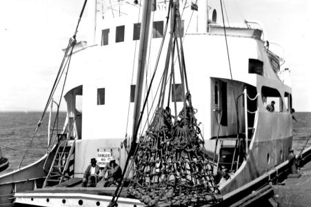 2 men sitting on the deck below the Bridge of the MV Blythe Star.