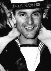 2 women kissing a smiling sailor from the HMAS Vampire on both cheeks.