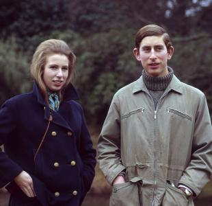 Standing together dressed in winter coats, Princess Anne and Prince Charles.