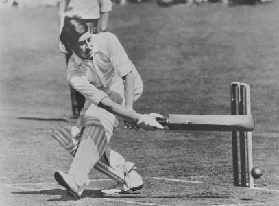 Prince Charles defending the wicket during a game of cricket.