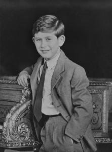 A young Prince Charles leans against a gilded Erard piano originally presented to Queen Victoria in 1856.