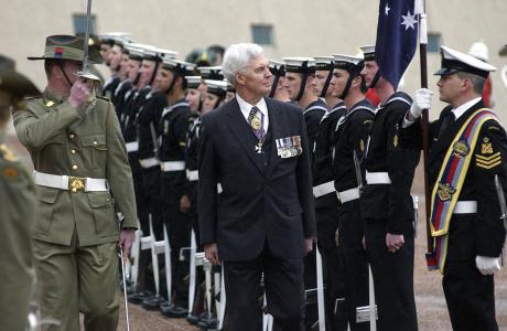 Governor-General Major General Michael Jeffrey inspecting a line of troops in uniform. 