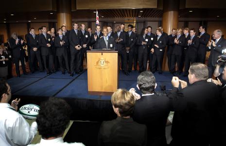 George Gregan giving a speech at a podium.