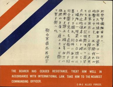 A leaflet with red and white stripes and text in Japanese and English script explaining the bearer has surrendered.