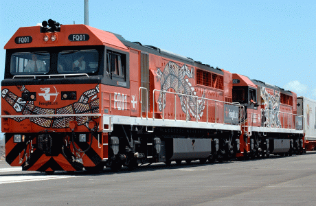 The inaugural freight train, decorated with the Larrakia artist Gullawun Daniel Roque Lee’s crocodile story, reaches its destination on the newly completed Adelaide to Darwin railway, January 2004. NAA: A14482, 040003DI-070. AUSPIC photographer: Michael Jones © Commonwealth of Australia, 2004